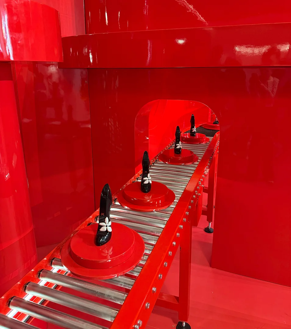 Good Girl shoes on the red conveyor at Carolina Herrera Good Girl Lab