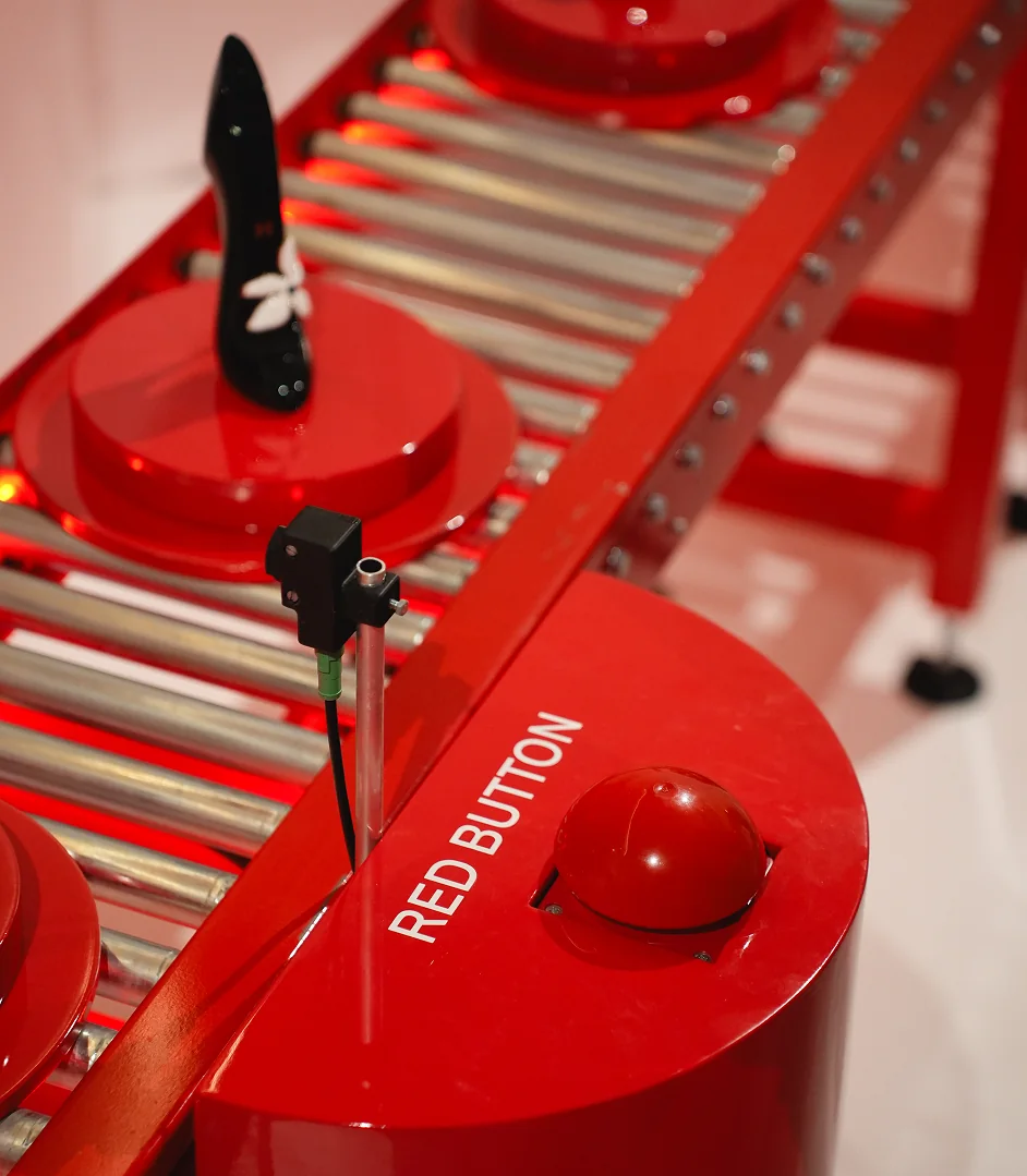 Red button beside the Good Girl shoe conveyor installation