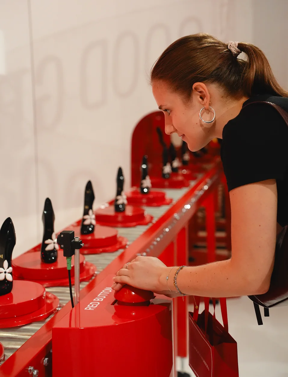 Visitor using the interactive Good Girl shoe conveyor